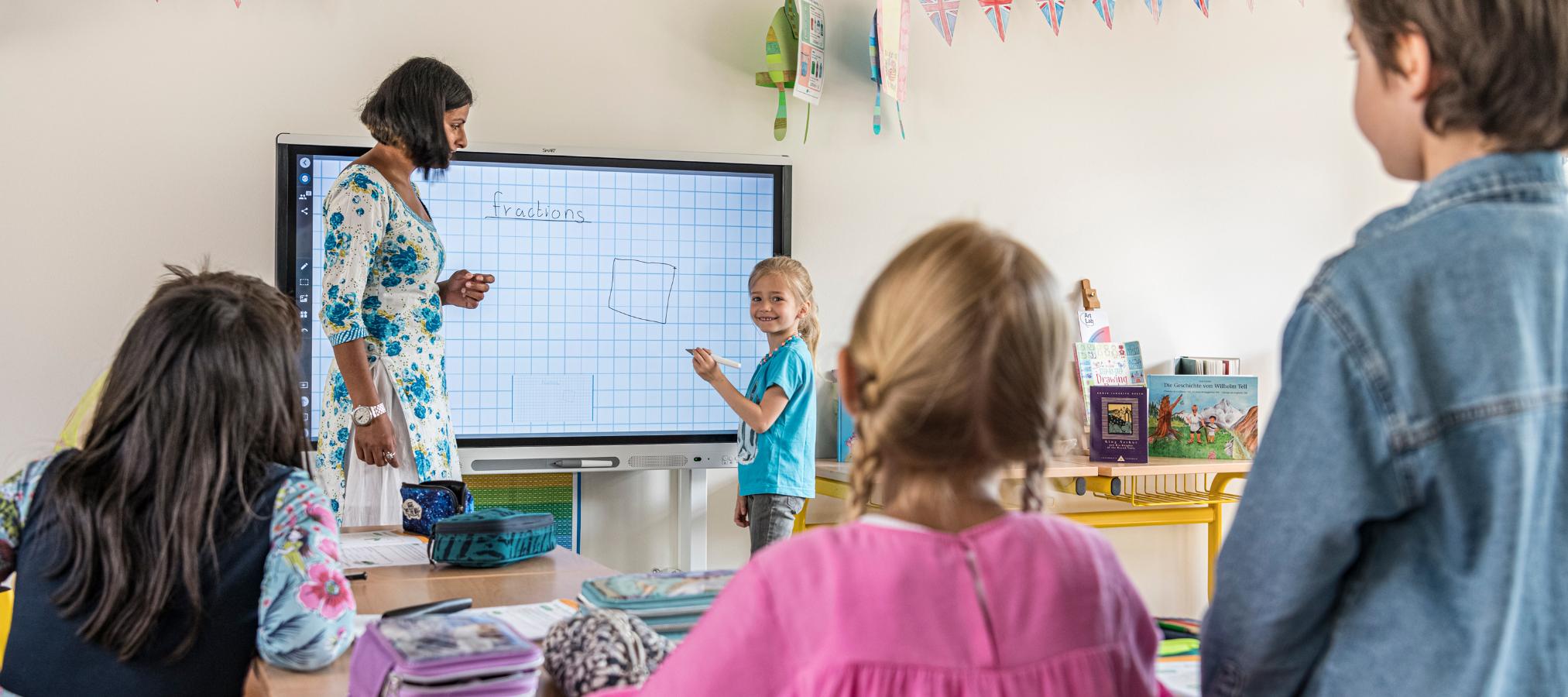 Teacher and child at interactive Whiteboard